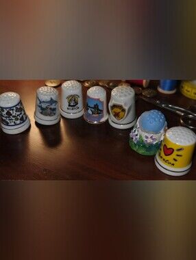 Set of 7 vintage souvenir porcelain thimbles with 24k. Colorado is ceramic